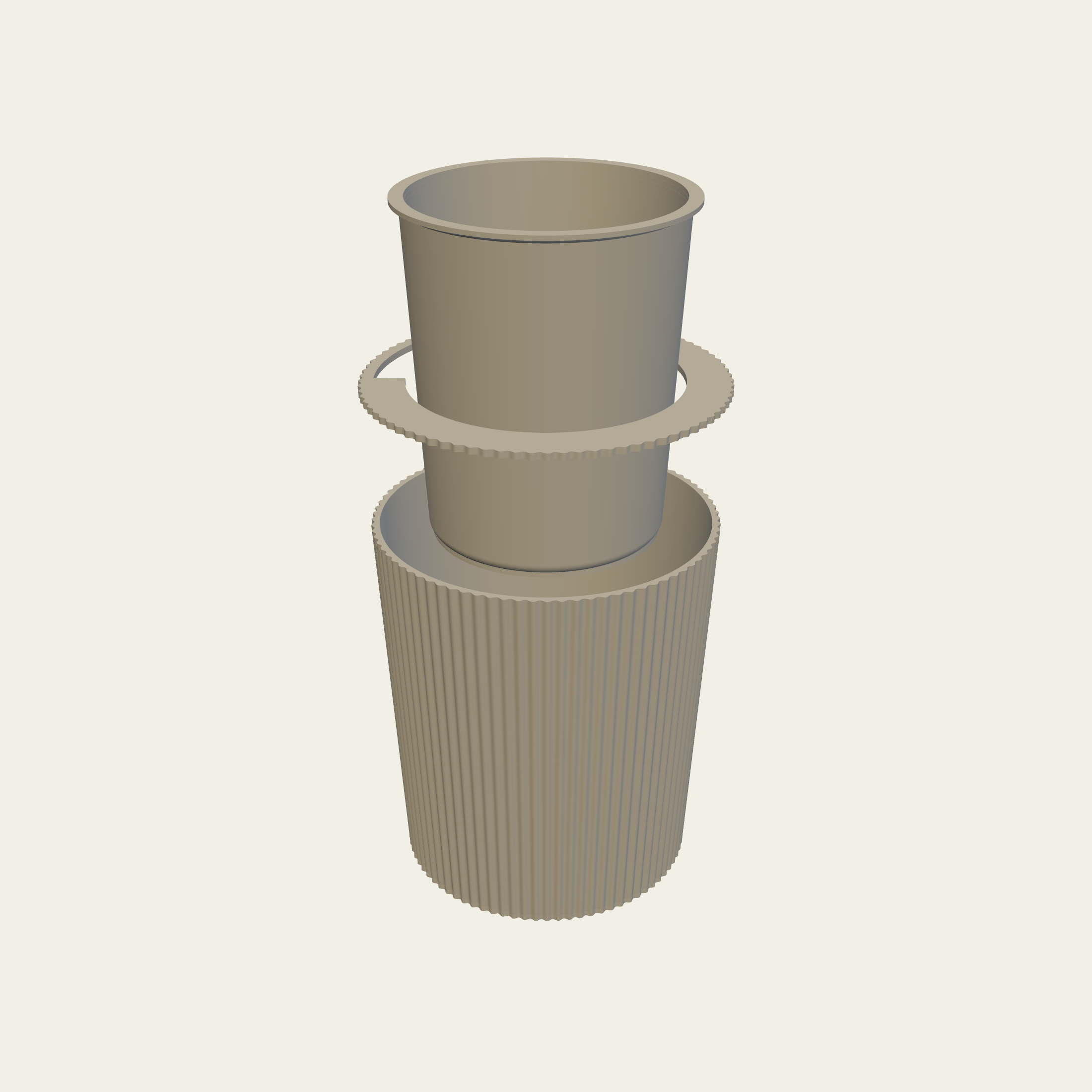 The pot lifted apart: the liner, the seat ring it hangs on, and the shell below.
